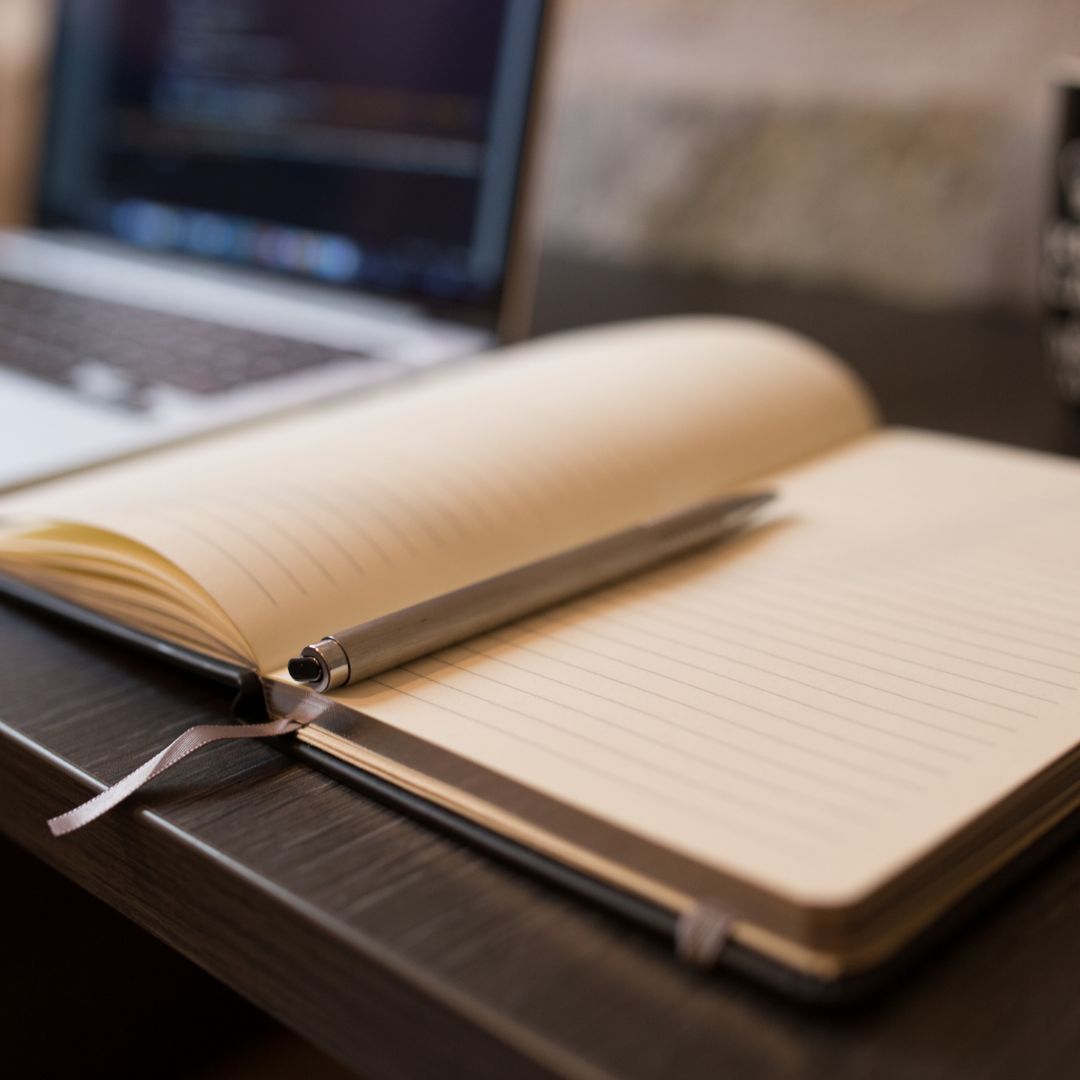 Creative Writing image of an open book with pen at the ready